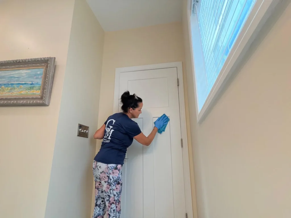 Cleaning Services GM team member wiping down door trim and baseboards during a detailed house cleaning in the Florida Keys