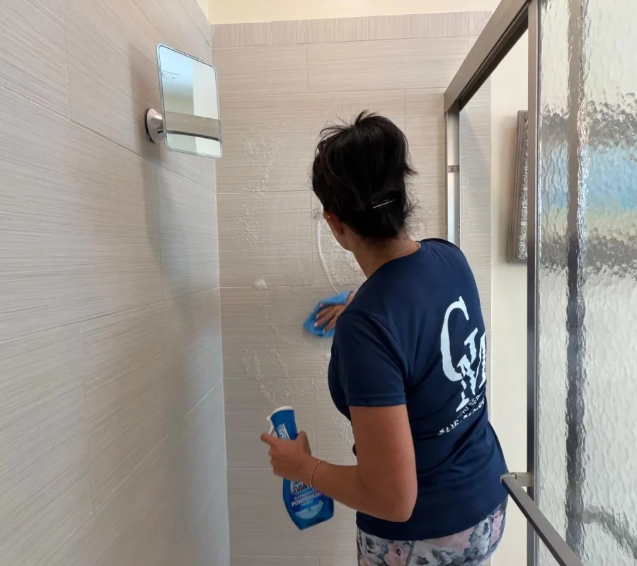 deep-cleaning-shower-grout-florida-keys Cleaning Services GM crew member scrubbing shower grout during a deep cleaning in the Florida Keys