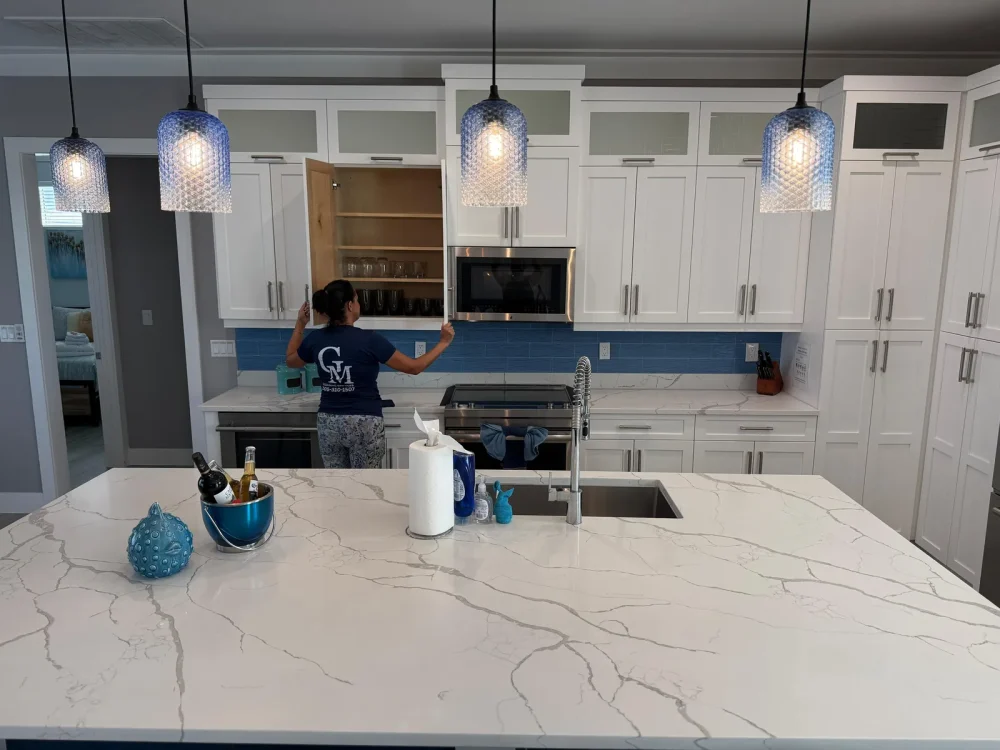 house-cleaning-kitchen-florida-keys Cleaning Services GM team member cleaning kitchen cabinets during a house cleaning in the Florida Keys