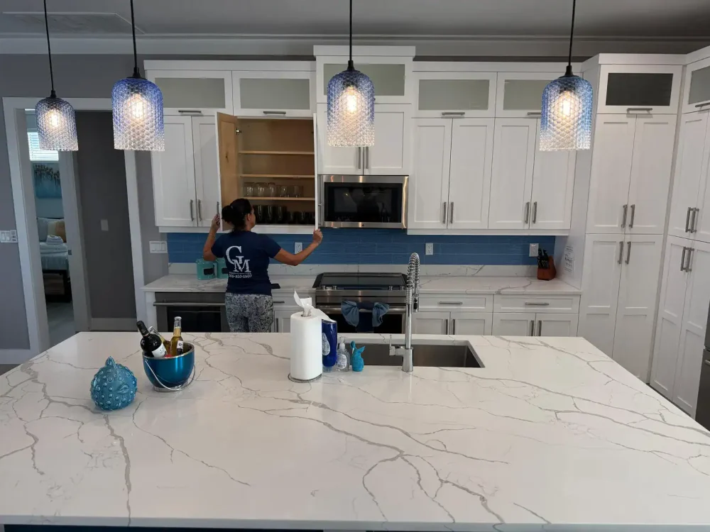 house-cleaning-kitchen-florida-keys Cleaning Services GM team member cleaning kitchen cabinets during a house cleaning in the Florida Keys