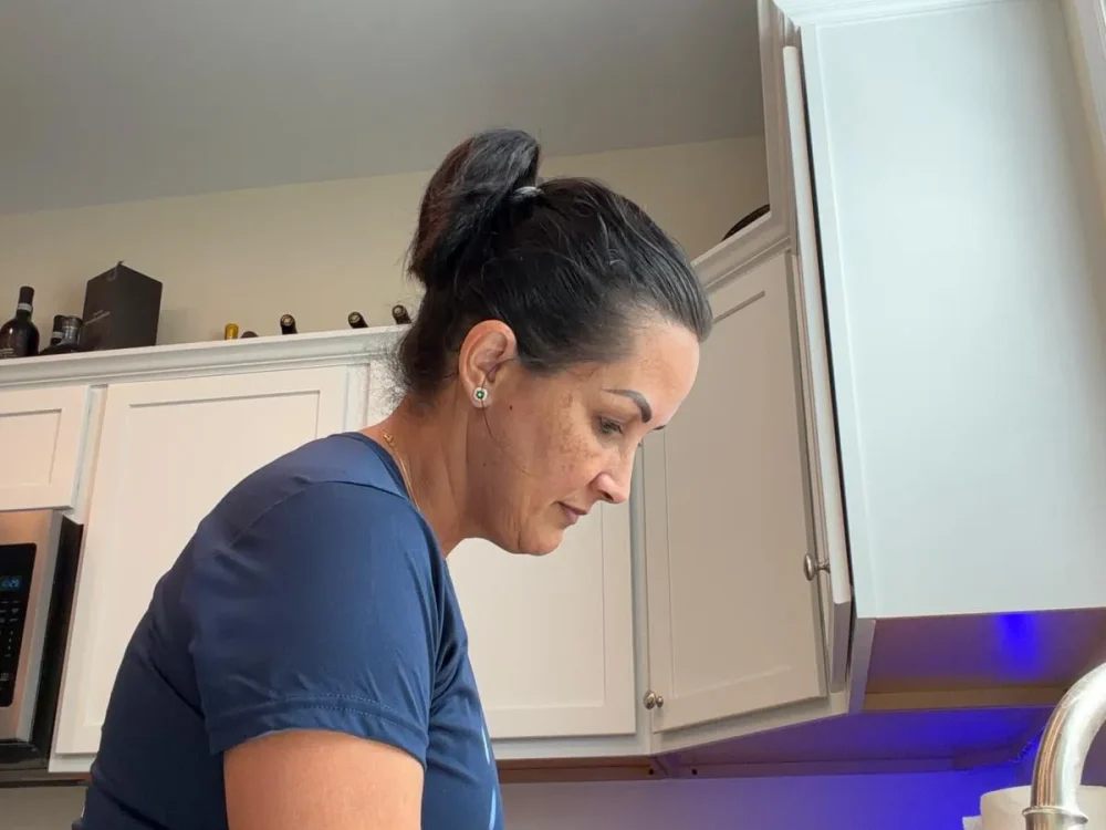 move-out-cleaning-kitchen-cabinets-florida-keys Cleaning Services GM team member wiping down kitchen cabinets during a move-out cleaning in the Florida Keys